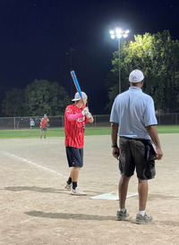 Two Adults playing baseball 