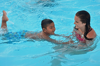 kid swimming with mother