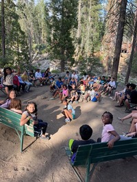 Group of kids in the wood doing the camp Fresno program 