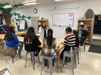 A teacher discussing to students