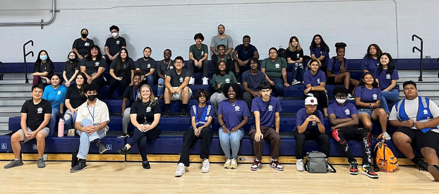 young kids sitting on the bleachers