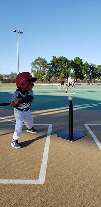 kid hitting the ball