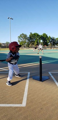 kid hitting the ball