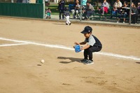 kid picking up ball