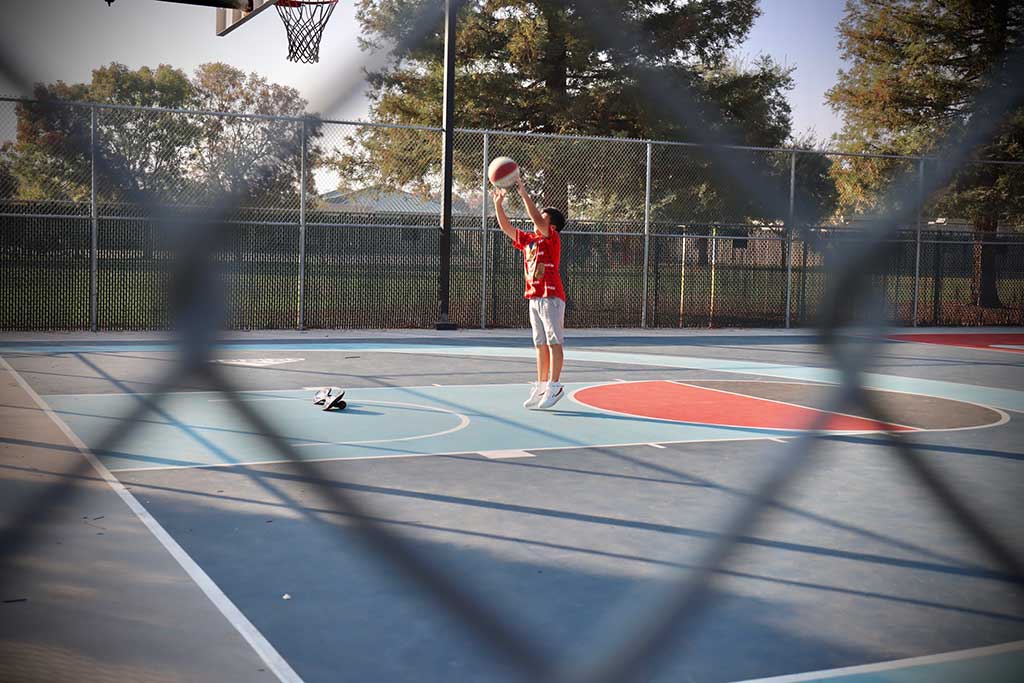 A kid shooting a basketball 