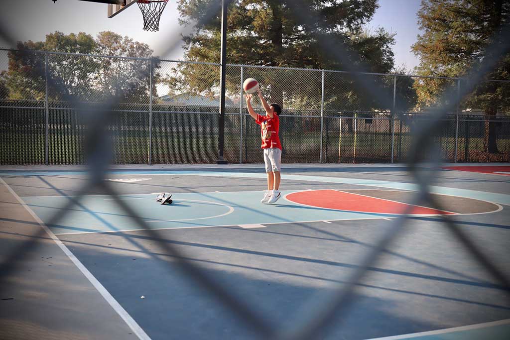 A kid shooting a basketball