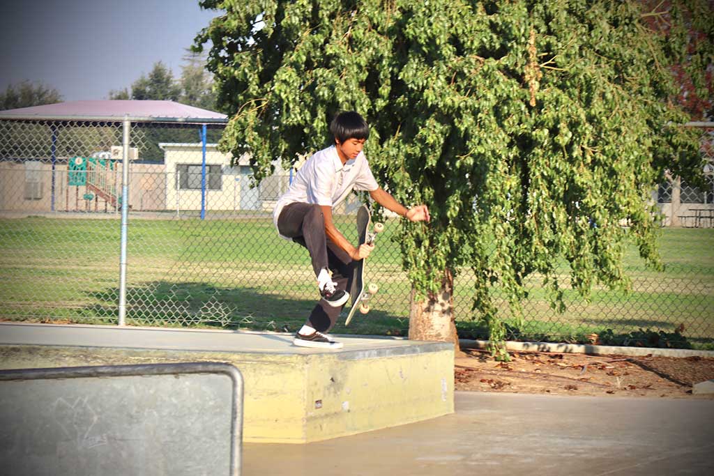 A kid that is about to skateboard