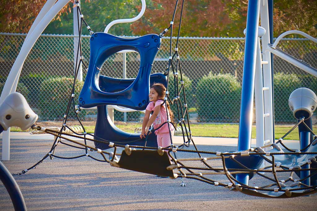 Kid on the swing and is swing back and forth