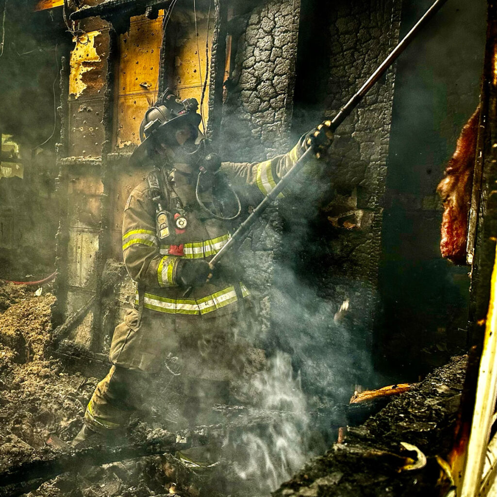 Firefighter overhauling Residential Structure Fire