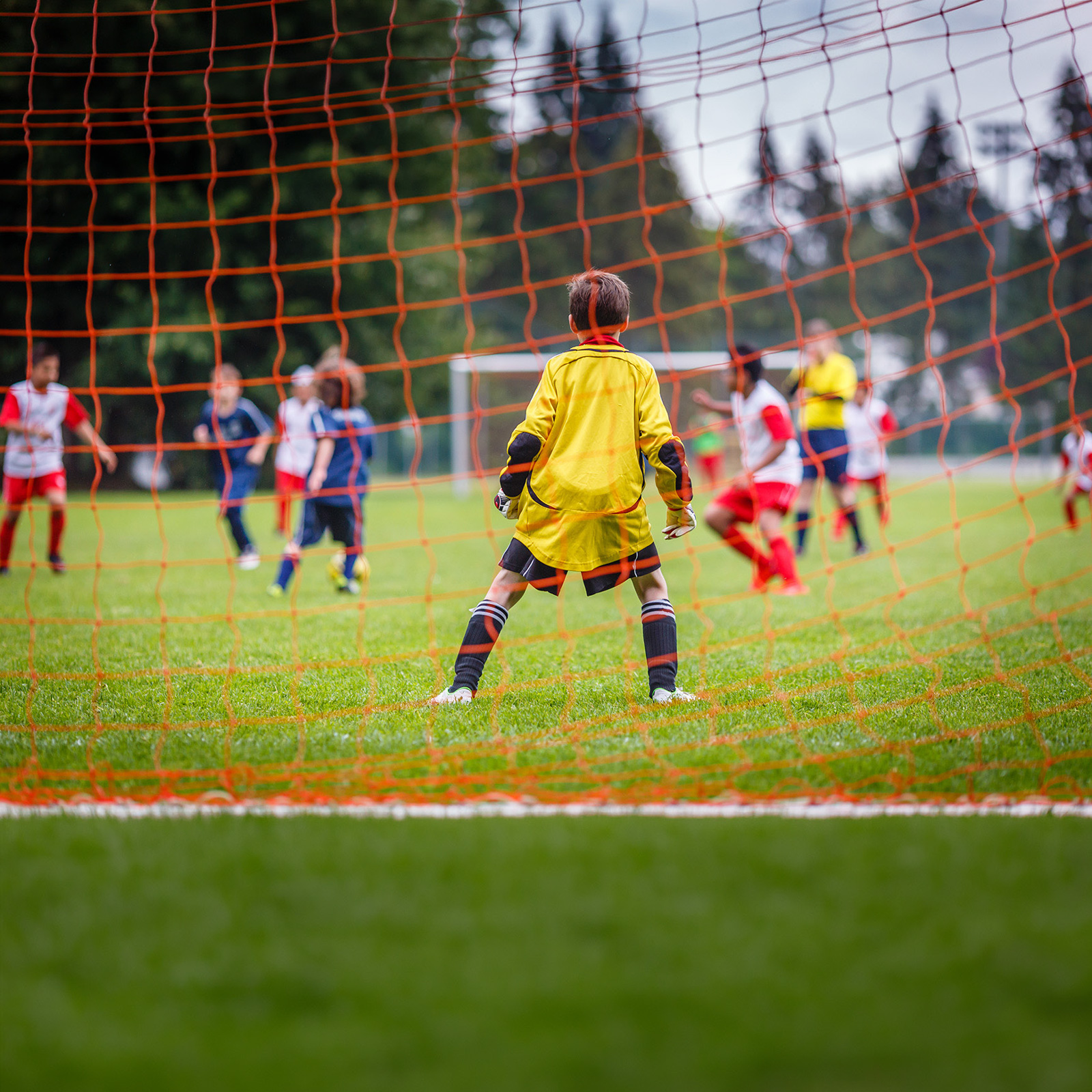 Child blocking goal at a park